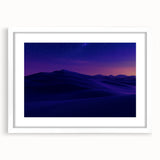 Desert landscape artwork framed with a white mat, showcasing warm earth tones and intricate details, perfect for home decor or office settings.