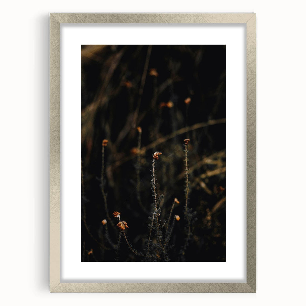 Textured abstract art print in orange and brown tones on a silver-framed canvas, ideal for bedroom wall decor.