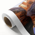Stunning rolled canvas artwork depicting majestic cliffs with vibrant colors, ideal for enhancing home decor, safely packaged in a protective cardboard tube.