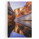 Stretched canvas artwork depicting a breathtaking cliff landscape at sunset, showcasing vibrant hues of orange and blue, perfect for home decor or office ambiance.