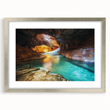 Silver-framed landscape print of canyons with a white mat, showcasing intricate details and vibrant colors, perfect for home or office decor.