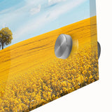 Close-up of a vibrant acrylic landscape artwork depicting a serene countryside scene, showcasing lush green fields and a bright blue sky, perfect for home decor.