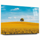 Vibrant acrylic landscape artwork showcasing a serene countryside scene, displayed in a glass frame without pins, highlighting lush green fields and a clear blue sky.