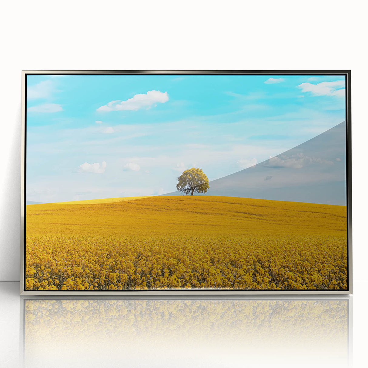 Framed acrylic artwork showcasing a serene countryside landscape with lush greenery and rolling hills, set in an elegant silver frame for a sophisticated decor accent. Ideal for home or office wall art featuring nature's beauty.