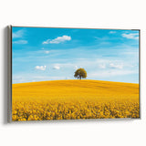 Framed landscape canvas showcasing a serene countryside scene with vibrant greens and blues, accented by a sleek silver frame, ideal for home decor enhancement.