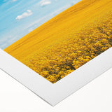 Rolled canvas artwork showcasing a vibrant countryside landscape with lush greenery and rolling hills, elegantly packaged in a protective cardboard tube for safe shipping.