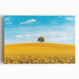 Stretched canvas artwork depicting a serene countryside landscape, showcasing vibrant green fields, a blue sky, and distant mountains, ideal for home decor.