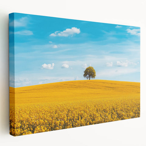 Stretched canvas artwork depicting a serene countryside landscape with rolling hills, vibrant green fields, and a clear blue sky, perfect for home decor.