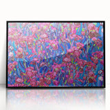 Large abstract wall art depicting swirling blue and yellow patterns on a black framed acrylic print.