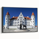 Framed canvas artwork depicting a stunning landscape with a majestic castle, set against a vibrant sunset backdrop, featuring a sleek black frame for an elegant display.