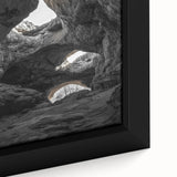 Close-up of a framed canvas print depicting a serene landscape with intricate cave formations, showcasing earthy tones and detailed textures, perfect for home decor.