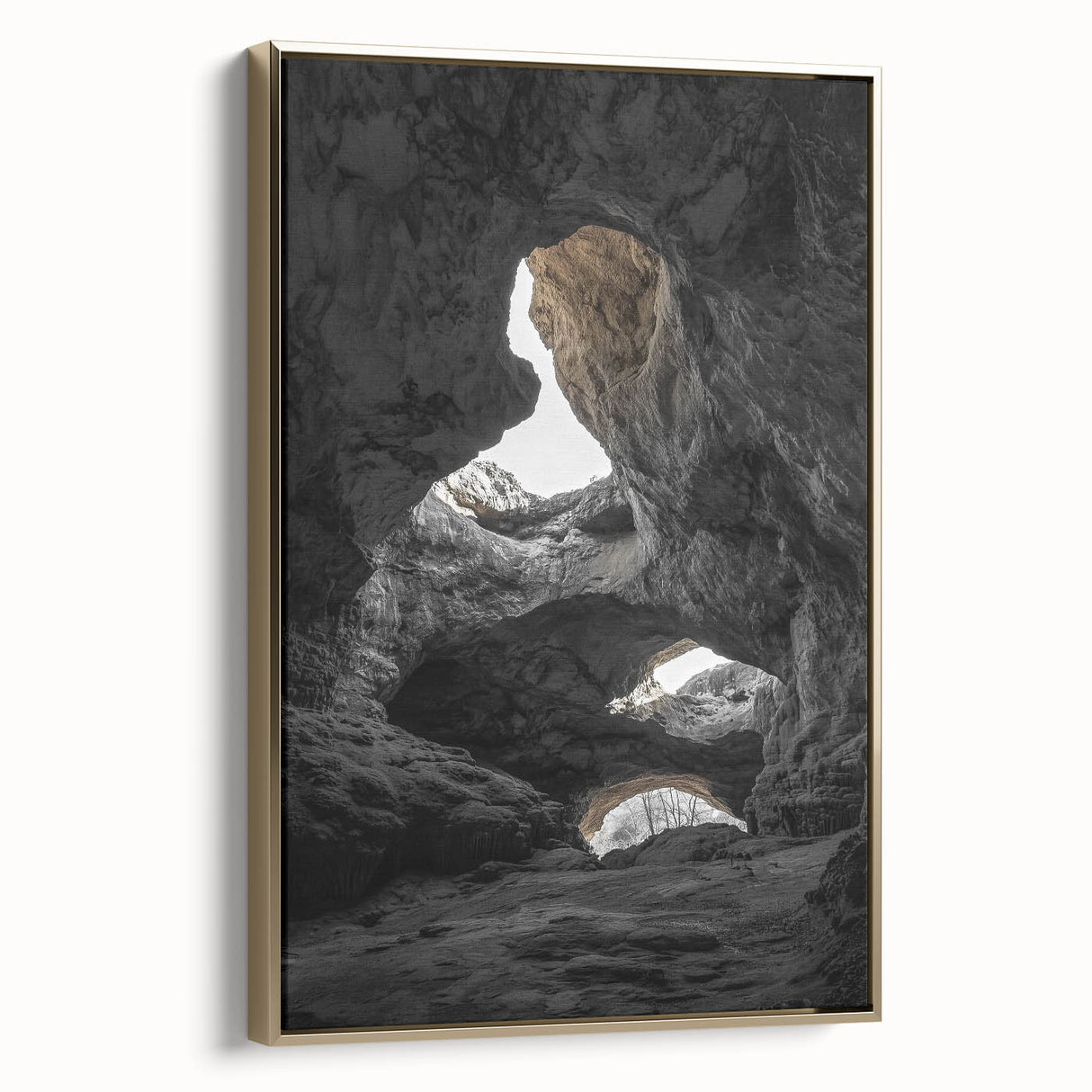 Framed canvas artwork depicting a stunning landscape with caves, featuring a gold border and side view, perfect for enhancing home decor or office spaces.