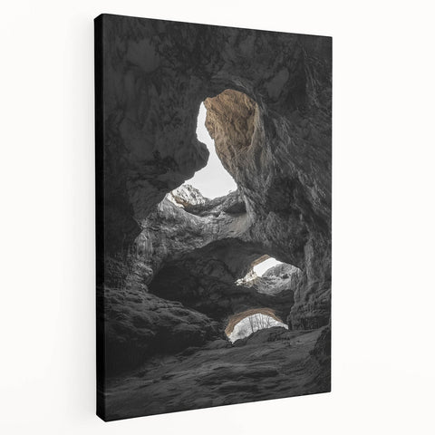 Stretched canvas artwork depicting a serene landscape with caves, showcasing earthy tones and intricate details, ideal for home decor or office spaces.