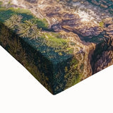 Close-up of a stretched canvas artwork depicting dramatic cliffs and landscapes, showcasing rich colors and detailed textures, ideal for home decor.