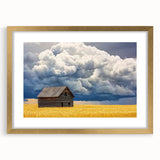 Framed landscape artwork of a barn scene with a gold mat, showcasing rustic charm and elegance, perfect for enhancing home decor in country-style interiors.