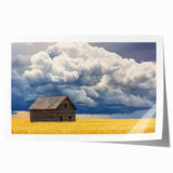 Rolled landscape print showcasing a rustic barn scene with vibrant colors and intricate details, packaged securely in a protective cardboard tube, ideal for home decor.