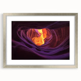Framed landscape artwork depicting vibrant canyons in shades of orange and brown, with a sleek silver mat, perfect for enhancing modern home décor.