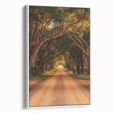 Framed canvas artwork depicting a serene countryside landscape with lush greenery and rolling hills, presented in a white frame, ideal for home decor.