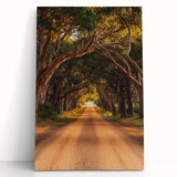 Stretched canvas artwork depicting a serene countryside landscape, featuring rolling hills, vibrant greenery, and a clear blue sky, adding a tranquil touch to home decor.