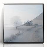 Large abstract wall art depicting a winter scene in muted gray and blue tones, framed in black acrylic.