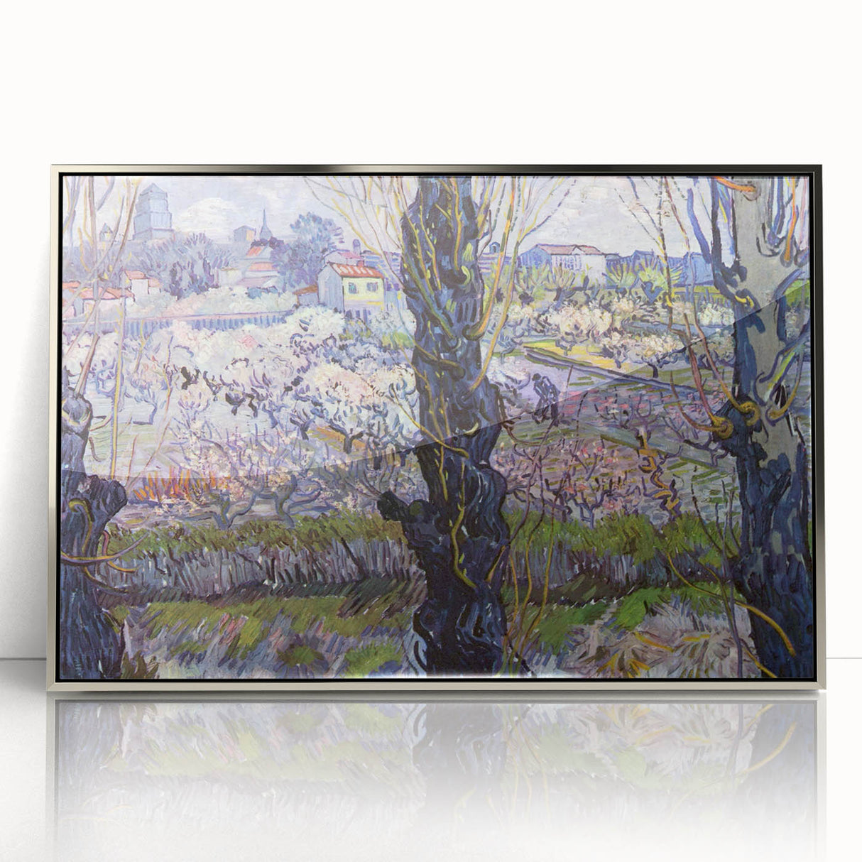 Large art print of Van Gogh's Starry Night in a silver frame, showcasing bold blue and yellow swirls.