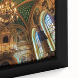 Close-up of a framed canvas depicting a serene landscape with a majestic castle, surrounded by lush greenery and a clear blue sky, perfect for home decor.