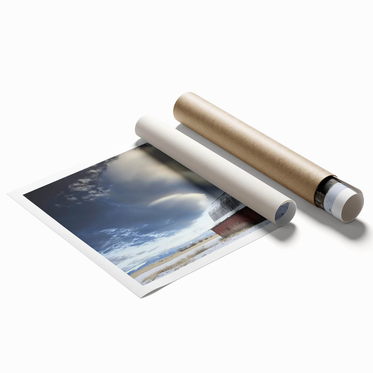 Landscape print of a rustic barn scene, showcasing vibrant greens and a clear blue sky, rolled up in a protective cardboard tube for easy transport. Ideal for home decor enthusiasts seeking country-themed art.
