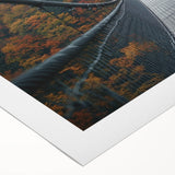 Rolled canvas artwork showcasing a vibrant landscape bridge design, featuring rich colors and intricate details, securely packaged in a protective cardboard tube for delivery.