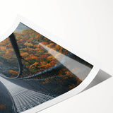 Rolled landscape print showcasing a picturesque bridge scene with lush greenery and a serene river, elegantly packaged in a protective cardboard tube for safe shipping.