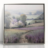 Framed landscape wall art depicting a serene countryside scene with lush green fields and a clear blue sky, accented by a sleek silver frame, perfect for home decor.