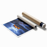 Vibrant rolled landscape print showcasing a serene countryside scene with rolling hills and a clear blue sky, packaged in a protective cardboard tube for easy transport.