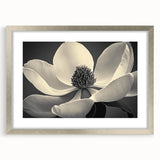Textured abstract art print featuring close-ups of florals in muted green and white tones, framed in silver.