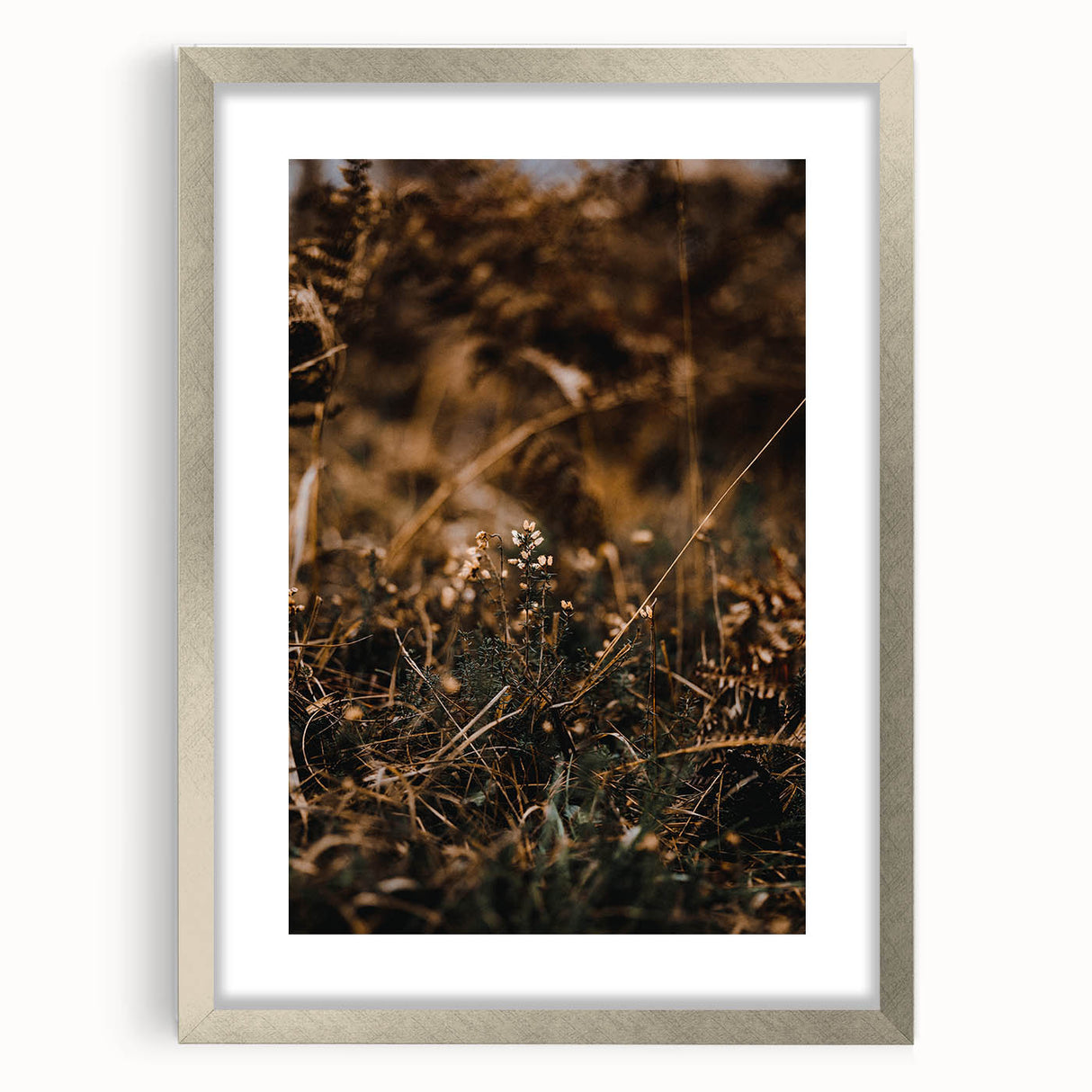 Textured abstract art print depicting fall colors in muted oranges and browns on a framed silver mat, ideal for bedroom art.