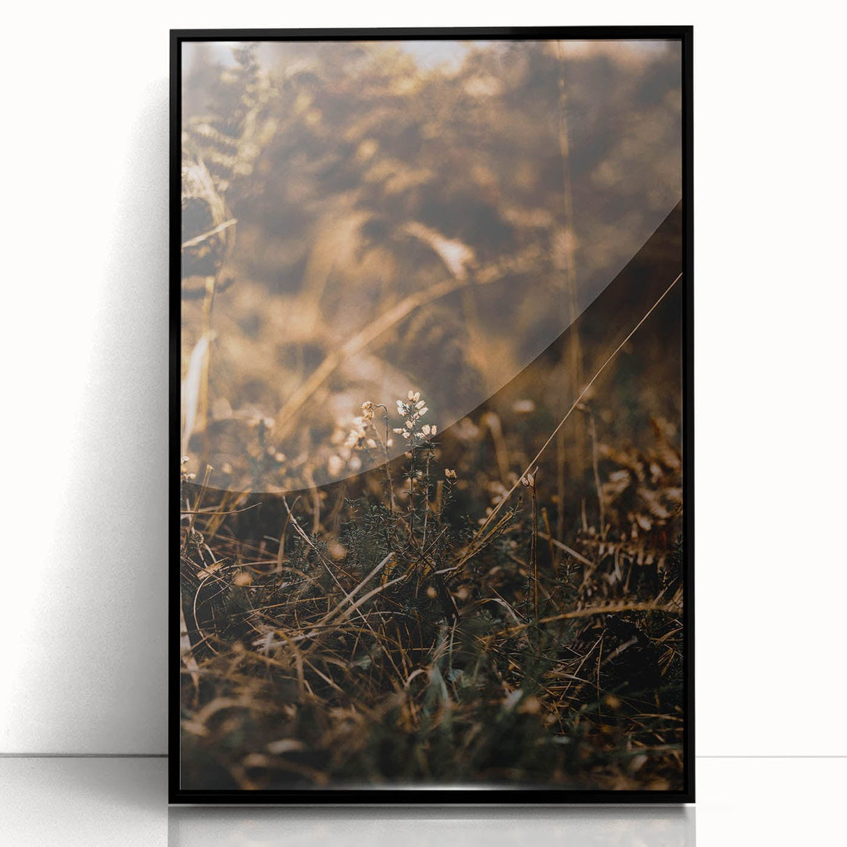Large abstract wall art depicting autumnal trees in warm orange and red hues, framed in black acrylic.