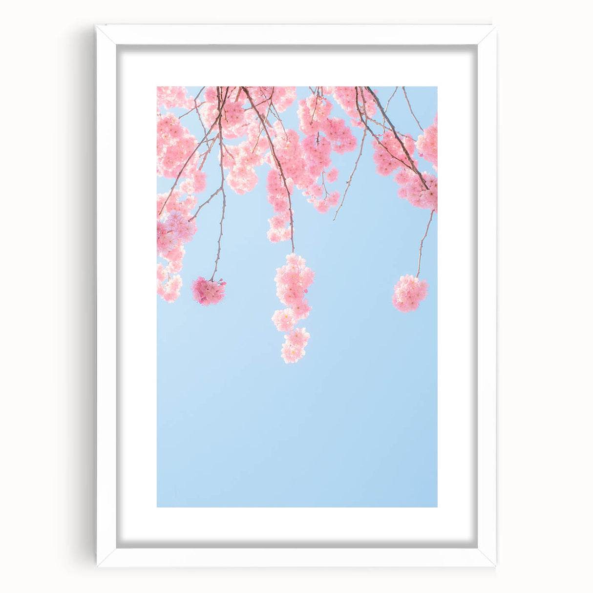 Abstract art print featuring spring-themed elements in soft green and pink, framed in white.