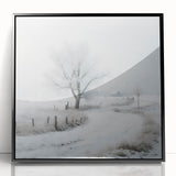 Large abstract wall art featuring a winter scene in muted blue and white tones, framed in black acrylic.