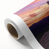 Rolled canvas print showcasing a vibrant landscape with a majestic castle set against a serene sky, expertly packaged in a protective cardboard tube for safe shipping.