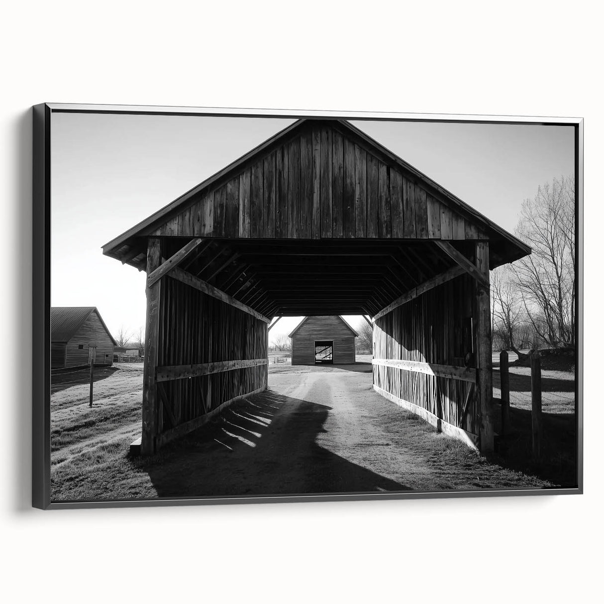 Black-framed landscape canvas featuring a serene barn scene, highlighting rustic charm and natural beauty, ideal for home decor or farmhouse aesthetics.