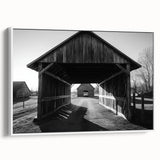 Framed landscape canvas featuring a serene barn scene with lush greenery, displayed from the side to highlight its elegant white frame and textured surface. Perfect for rustic home decor enthusiasts seeking to enhance their interior aesthetics.