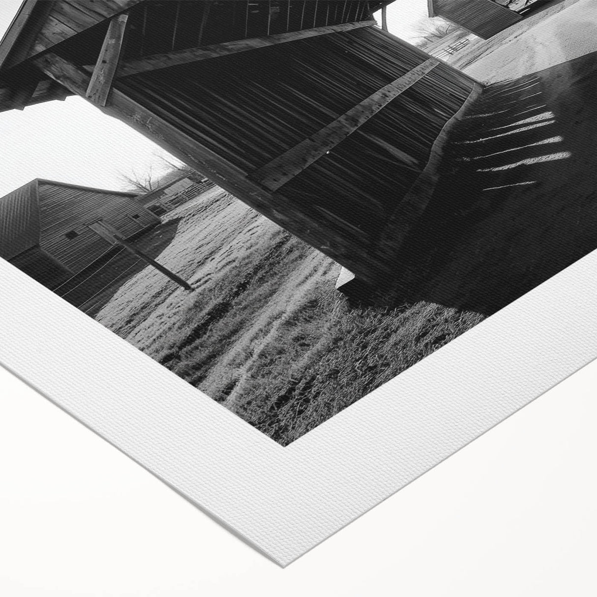 Rolled canvas displaying a vibrant landscape design with rustic barns and lush greenery, packaged securely in a cardboard tube for safe transport and storage.