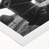 Rolled canvas displaying a vibrant landscape design with rustic barns and lush greenery, packaged securely in a cardboard tube for safe transport and storage.
