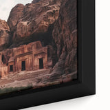 Close-up of a framed landscape canvas showcasing a vibrant canyon scene, highlighting rich hues of red and orange, perfect for adding warmth to home decor.