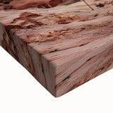 Close-up of a stretched canvas depicting a vibrant desert canyon landscape with rich orange and red hues, showcasing intricate textures and depth, perfect for home decor.