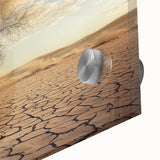 Close-up of a vibrant acrylic landscape painting depicting a serene desert scene with warm tones of orange and yellow, highlighting intricate details and textures.