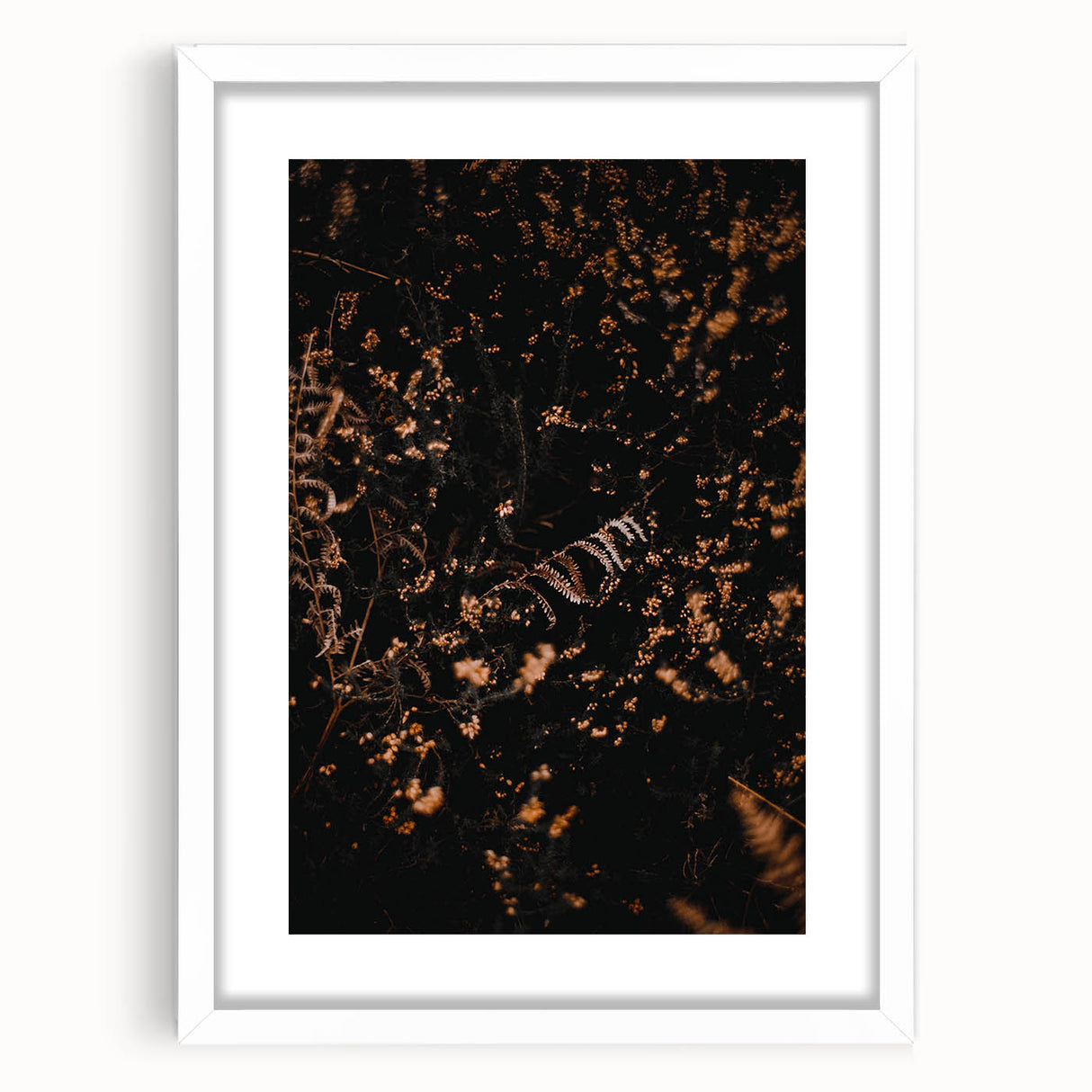 Abstract art print depicting autumnal trees in orange and red tones on a white framed canvas.