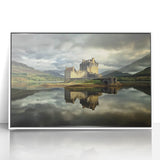 Framed acrylic artwork depicting a serene landscape featuring a majestic castle surrounded by lush greenery, presented in a sleek white frame, ideal for home decor.