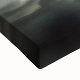 Close-up of a stretched canvas artwork depicting a serene landscape with a majestic castle surrounded by lush greenery and blue skies, ideal for home decor.