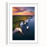 Framed landscape artwork showcasing dramatic cliffs under a clear blue sky, with a white mat enhancing its elegance, perfect for modern home decor.