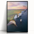 Framed acrylic artwork showcasing dramatic landscapes with towering cliffs, set against a vibrant sunset, featuring a sleek black frame for modern decor appeal.