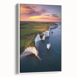 Framed canvas artwork depicting a scenic landscape with majestic cliffs, featuring soft earthy tones and a white border, ideal for home decor enhancement.